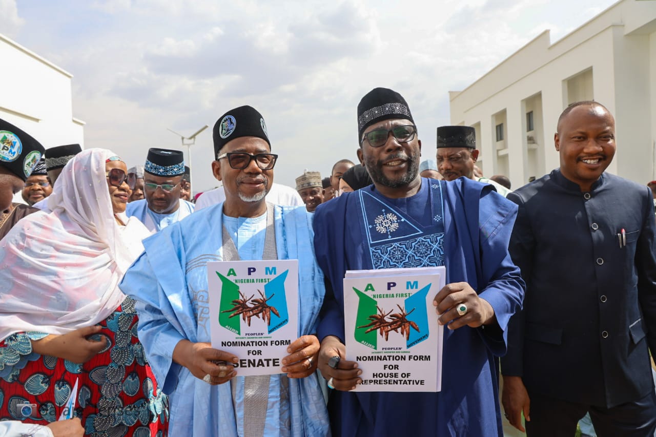 APM officials holding party nomination forms at a public party activity